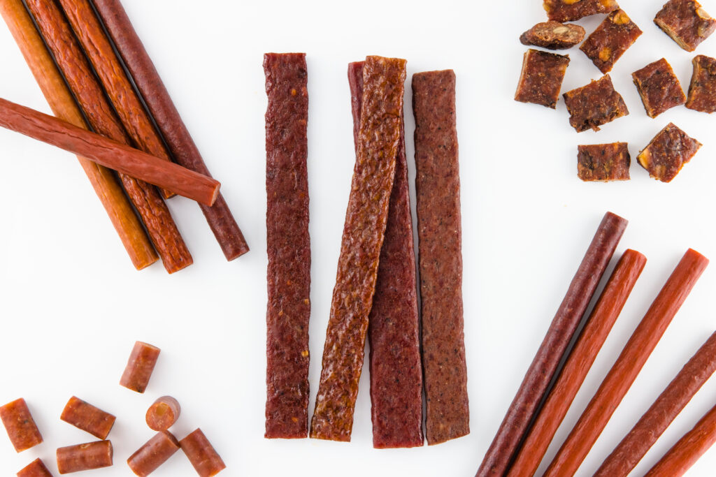 Image of various types of meat products that we make including meat sticks, ground and formed strips, snack stick bites, ground and formed bites. 